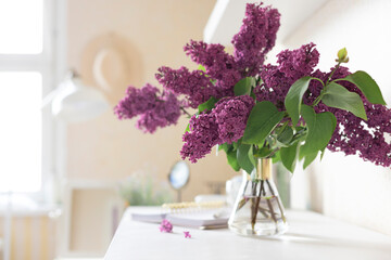Bouquet of Violet lilac in a vase on the dressing table. Close up	