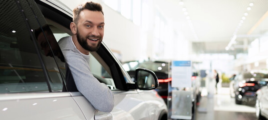 a satisfied customer purchases a new car at a dealership