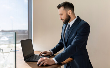 businessman man working on a laptop in a stylish suit