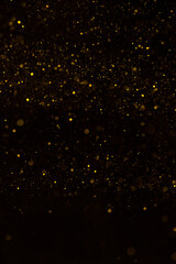 Abstract golden glitter lights dark background
