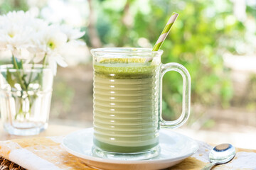 Color latte protein healthy vegan shake. A cup of hot matcha latte on wooden floor