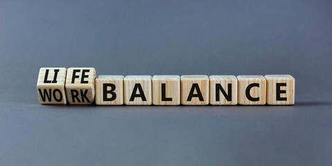 Work life balance symbol. Turned wooden cubes and changed concept words Work balance to Life balance. Beautiful grey table grey background. Business work life balance concept. Copy space.