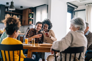 Multiethnic, three generation family together celebration with parents grandparents and children