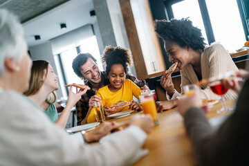 Multiethnic diverse extended family dining and toasting together