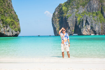 happy tourist man at Maya Bay beach on Phi Phi island, Krabi, Thailand. landmark, destination Southeast Asia Travel, vacation and holiday concept