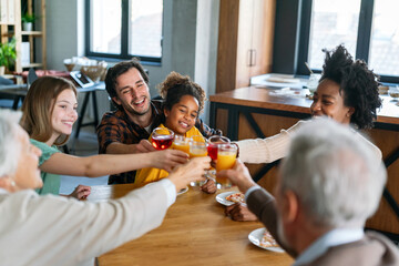 Multiethnic diverse extended family dining and toasting together