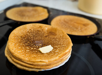 cooking traditional pancakes from wheat flour in the kitchen