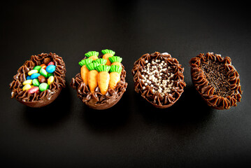 Easter eggs filled with brigadeiro on black background, easter concept.