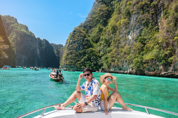 Couple tourist on boat trip, happy travellers relaxing at Pileh lagoon on Phi Phi island, Krabi,...