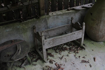 an old baby cot is in the woods