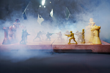 War concept. Silhouettes of soldiers on chessboard. War Concept. Military silhouettes fighting...