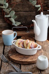 Cottage cheese pancakes with condensed milk. Side view, wooden background. Syrnik