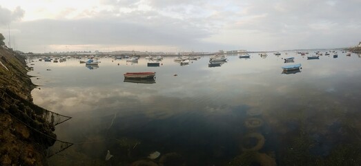 A lot of boats docked on a cloudy day