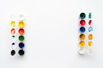 Flat composition a set of multi-colored paints in jars. Space for the text.