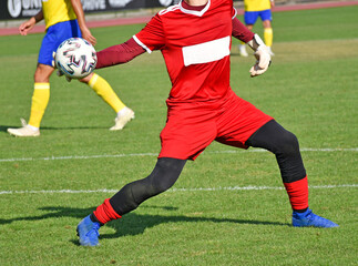 Goalkeeper with ball in the soccer match