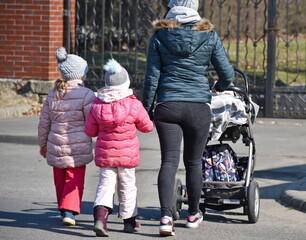 Mother and children are walking on the street