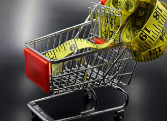 yellow tape measure on shopping cart 