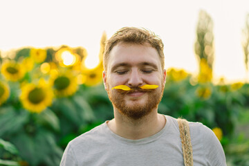 Man with yellow flowers in mustache. Breathe free. A man has fun in nature. Happy man no allergy....