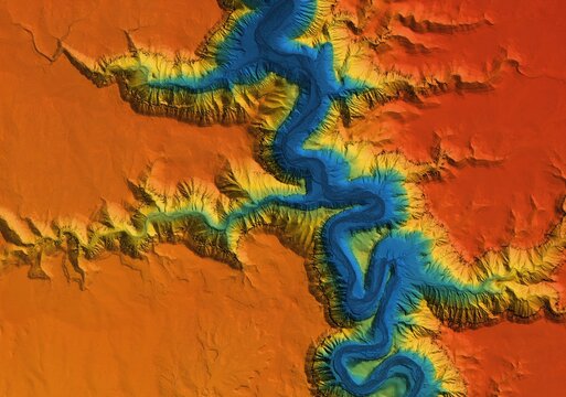Digital elevation model of a deep stone canyon. A meandering and curving river below. GIS 3D product made after proccesing aerial data.