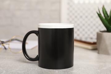 Mug of hot drink on light grey table in office. Coffee Break