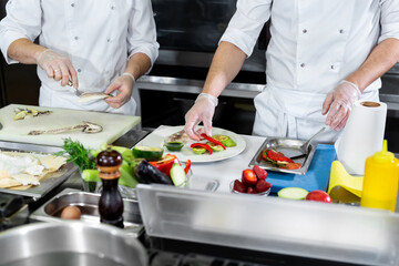Obraz na płótnie Canvas Chefs prepare meals in the kitchen