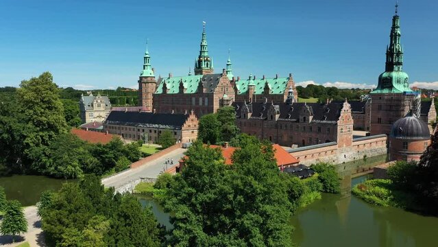 Descending aerial drone shot of Frederiksborg Castle and its surroundings in Hillerod Denmark