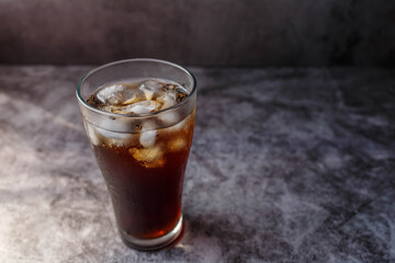 cola drink in a glass with ice