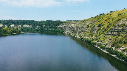 The river flows near the horizon of the mountain range. Natural landscape view