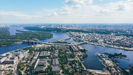 Fly over the buildings of the big city. Aerial view of the cityscape and river