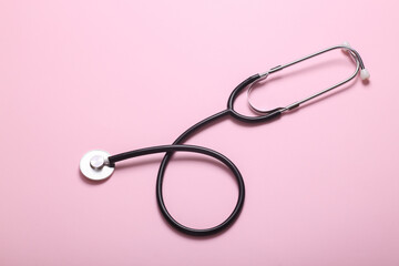 Medical stethoscope on pink background. Top view. Flat lay