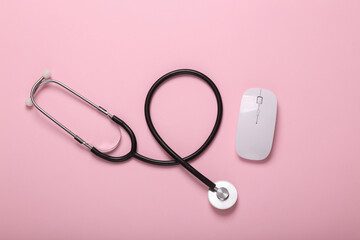 Pc mouse with stethoscope on pink background
