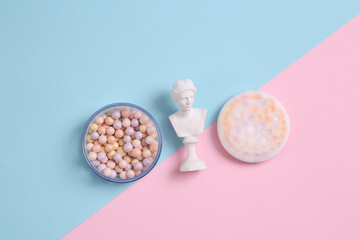 Minimal beauty still life. Plaster venus bust with balls powder on blue pink pastel background
