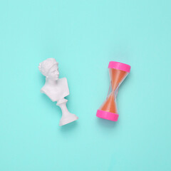 Antique David bust with hourglass on blue background