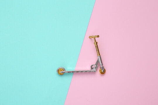 Model scooter on a blue-pink background. Top view