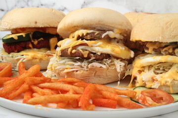 Freshly made hamburger with cheese sandwich and french fries