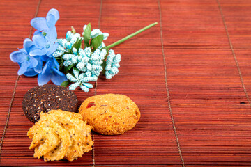 With vegan cookies and flower isolated on a wooden background. Space for text.
