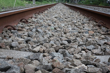 Close up and detailed photos of the commuter rail section and the gravel around it               