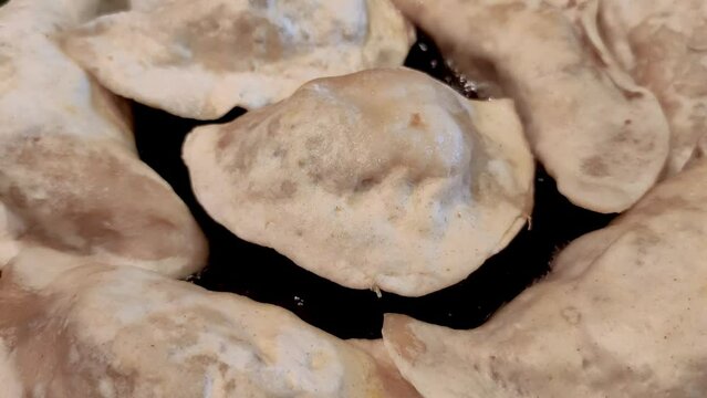 Fry Polish pierogi on pan. Pierogi is variety of filled dumplings.
