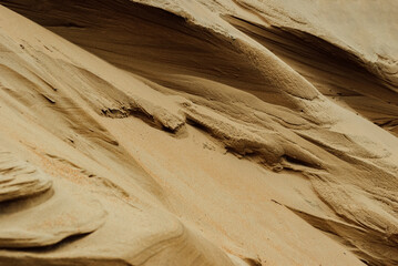 background of yellow sandy mountains and textured waves outdoors