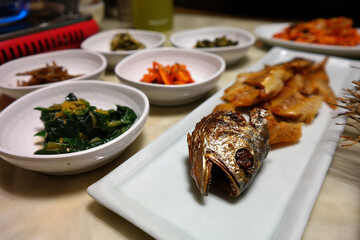 Barley-aged Dried Yellow Croaker and various Korean side dishes are served.