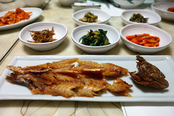 Barley-aged Dried Yellow Croaker and various Korean side dishes are served.