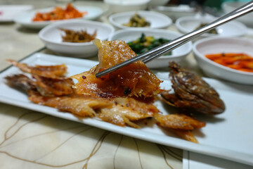 Barley-aged Dried Yellow Croaker and various Korean side dishes are served.