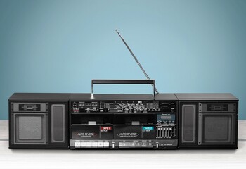 Retro boombox ghetto blaster outdated portable radio receiver with cassette recorder on the desk