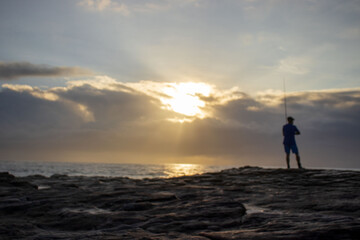 Seascape view with people fishing from the shore line on the South Coast of South Africa