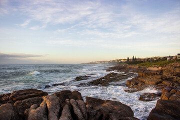 Seascape view with people fishing from the shore line on the South Coast of South Africa