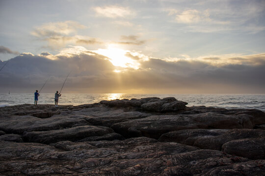 Seascape View With People Fishing From The Shore Line On The South Coast Of South Africa