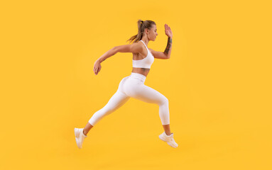 Fototapeta na wymiar active sport girl runner running on yellow background