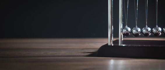 Newton's cradle balls on the wooden table. Business