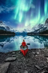 Poster Beautiful aurora borealis over spirit island with female traveler on canoe at Jasper national park © Mumemories