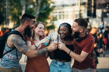 Group of friends drinking cocktails and having fun at music festival